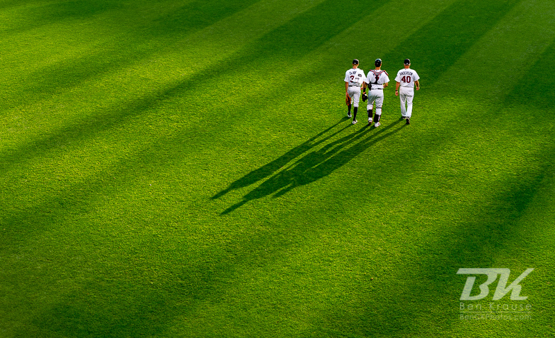 Cole Devries (38), Joe Mauer (7), and Rick Anderson (40)
of the Minnesota Twins head for the dugout before a game against the Tampa Bay Rays on August 10, 2012 at Target Field in Minneapolis, Minnesota.  The Rays defeated the Twins 12 to 6.  Photo: © Ben Krause 2012